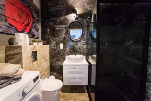 a bathroom with a toilet and a sink and a mirror at APARTAMENT KAMILA in Gdańsk