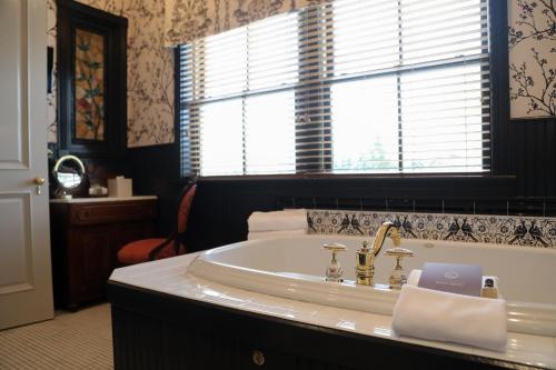 a bathroom with a sink and a window at The Chanler at Cliff Walk in Newport