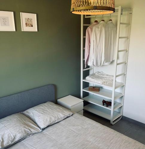 a bedroom with a closet with a bed and a lamp at Maison en pierres au calme près d'Ancenis in Mésanger