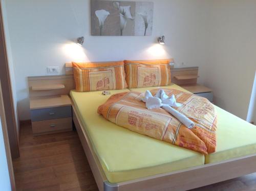 a bedroom with a bed with a bow on it at Gasthaus Jaufenblick in San Martino