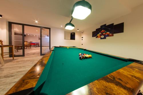 a snooker table in a living room with a pool at Hotel Gran Pre in San Vigilio Di Marebbe
