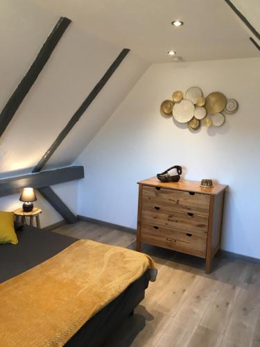 une chambre avec un lit et une commode en bois dans l'établissement Le coin américain, à Horbourg-Wihr