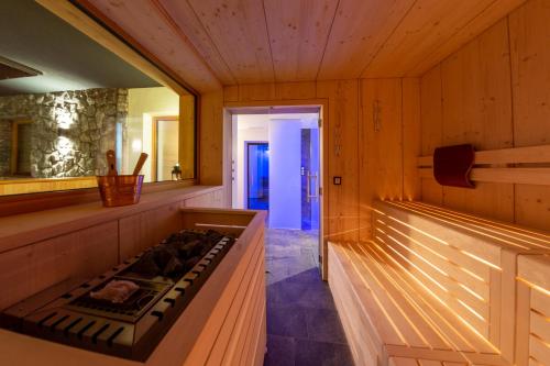 a kitchen with a stove in a wooden room at Hotel Gran Pre in San Vigilio Di Marebbe
