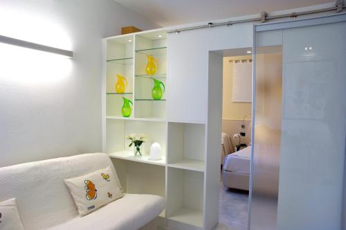 a living room with a glass door to a bedroom at Hotel Eros Residence in Cervia
