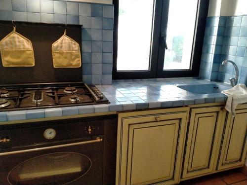 a kitchen with a stove and a sink at Villa Rossi in Polignano a Mare