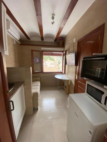 an interior view of a kitchen in a rv at Casa Rural Los Amaneceres in Alcalá del Júcar
