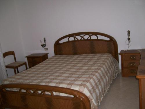 a bedroom with a bed and two tables and a dresser at Adamo in Calatafimi