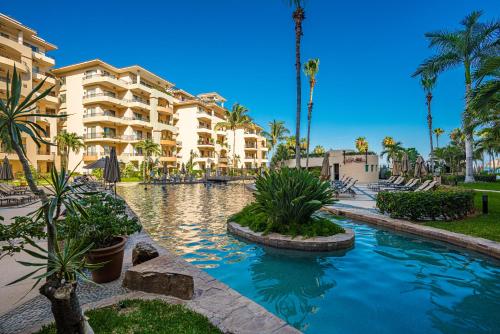 a resort with a swimming pool in front of a building at Villa La Estancia - Medano Beach Villas in Cabo San Lucas