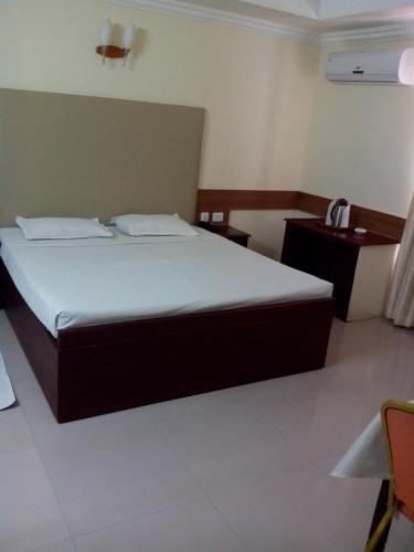a bedroom with a large bed in a room at Paray Village County in Kollengode
