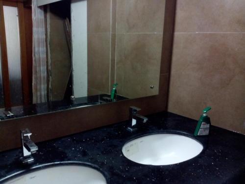 a bathroom with two sinks and a large mirror at Paray Village County in Kollengode