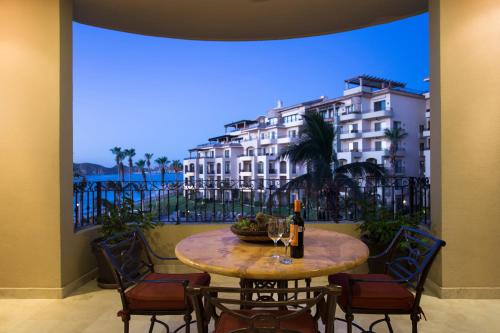 a table and chairs with a view of a building at Villa La Estancia - Medano Beach Villas in Cabo San Lucas