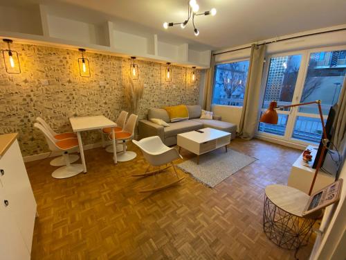 un salon avec un canapé et une table dans l'établissement Cosy pretty flat, à Saint-Étienne