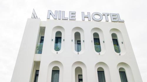 a white hotel with a nile hotel sign on top at Nile Hotel Phu Yen in Tuy Hoa