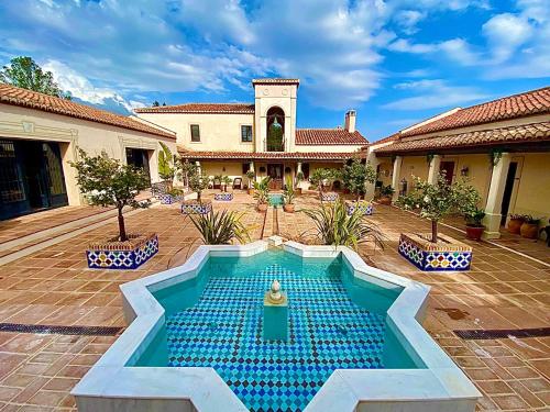 a swimming pool in the middle of a courtyard at La Esperanza Granada Luxury Hacienda & Private Villa in Saleres