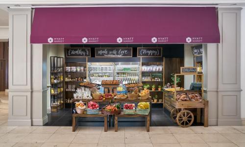 a grocery store with a purple awning with food at Hyatt Regency Bishkek in Bishkek