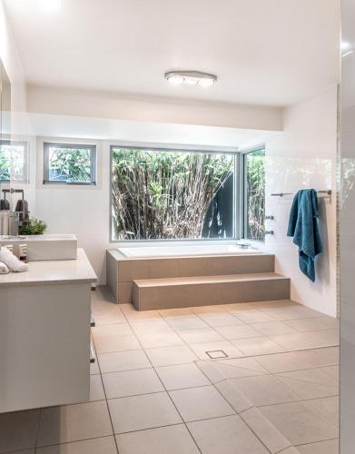 a bathroom with a sink and a large window at Noosaville Hideaway in Noosaville