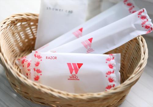 a basket filled with white and red envelopes at Hotel Wing International Chitose in Chitose