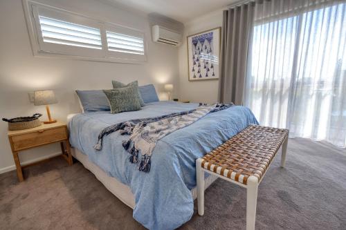a bedroom with a large bed and a window at Hidden Oasis - Peregian Beach in Peregian Beach