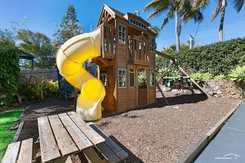 a small playground with a house and a slide at Hidden Oasis - Peregian Beach in Peregian Beach