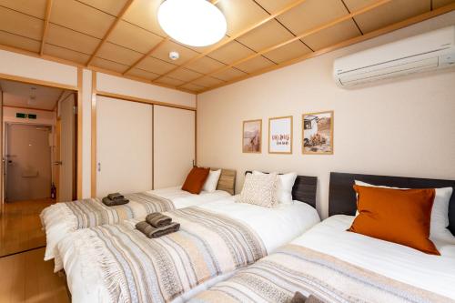 Cama ou camas em um quarto em Type C Room 40平米 -ウル エスポワール那覇-