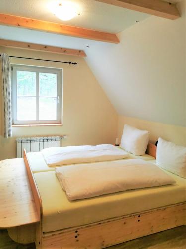 a large bed in a room with a window at Pension Bella Vista - Winzerhof Golk in Meißen