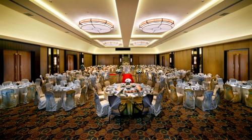 a room filled with tables and chairs in a room at The Saujana Kuala Lumpur in Subang Jaya