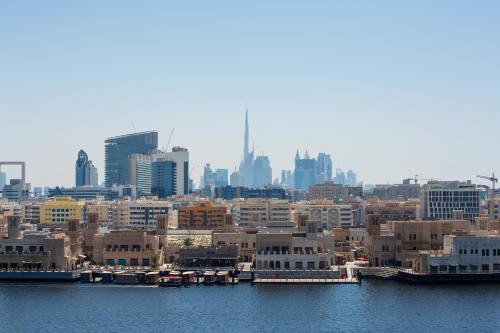 a view of a city with buildings and water at Riviera Hotel in Dubai