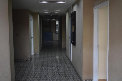 an empty hallway of an office building with a hallway at Hotel Sky INN in Rawalpindi