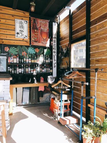 a restaurant with a bar with a lot of alcohol at South Talk B&B in Hengchun