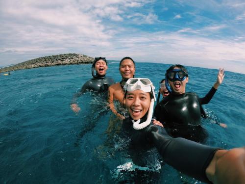 a group of people swimming in the water at South Talk B&B in Hengchun