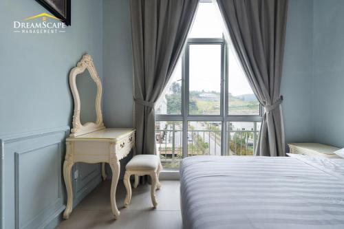 a bedroom with a desk and a bed with a window at Zetter Suites @ Cameron in Cameron Highlands