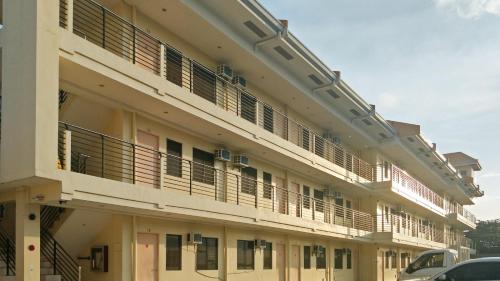 a large building with balconies on the side of it at RedDoorz Plus near Talisay Town Center in Talisay