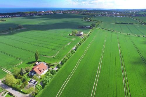 an aerial view of a large green field with a house at Ferienwohnungen Kleckerburg mit Me in Kägsdorf
