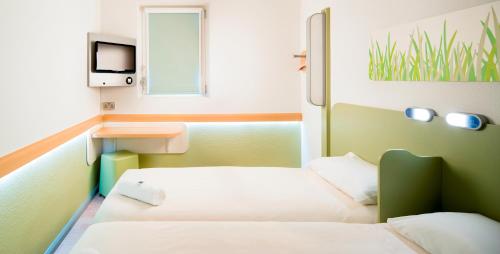 Кровать или кровати в номере ibis budget Hotel Edinburgh Park