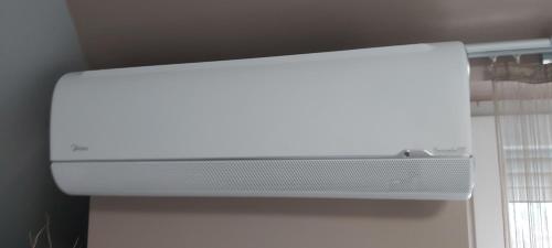 a white computer monitor sitting on top of a wall at Hétvezér Penthouse Apartments in Szeged