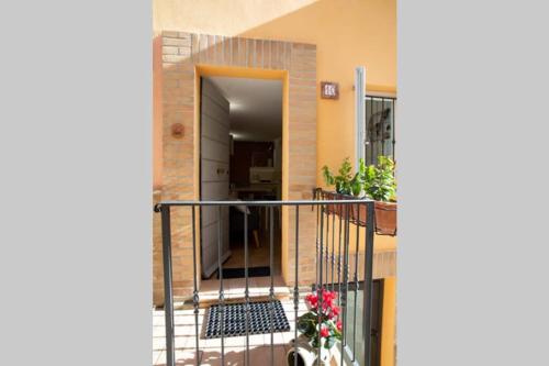 a balcony of a building with a staircase with flowers at La Casetta - Casa Indipendente nel centro storico in Fermo