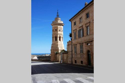 a lighthouse in the middle of a street next to a building at La Casetta - Casa Indipendente nel centro storico in Fermo