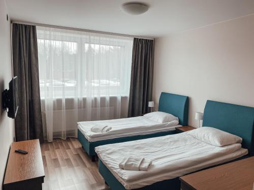 a hotel room with two beds and a window at "AVA" apgyvendinimo įstaiga in Vilnius