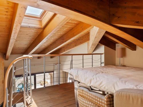 a bedroom with a bed and wooden ceilings at Tassido Coda Resort in Scanno