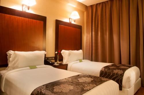 a hotel room with two beds and curtains at Park Avenue Hotel Nungambakkam in Chennai