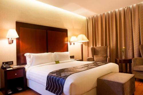 a hotel room with two beds and a lamp at Park Avenue Hotel (Near US Consulate & Sankara Nethralaya Hospital) in Chennai