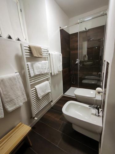 a bathroom with a toilet and a sink and a shower at Al Ponte Nuovo in Ponte di Legno