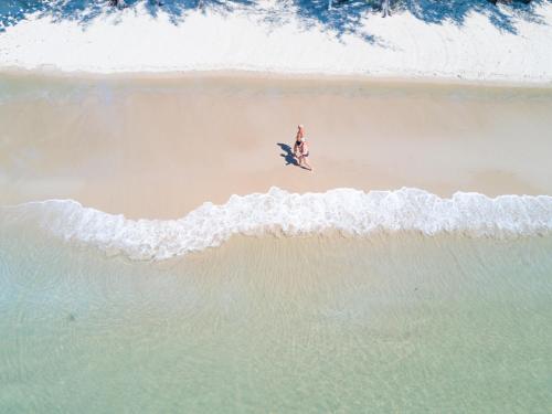 an overhead view of a person standing on a beach at Mantra Beach Condominium Suite - Mae Phim in Ban Tha Fat