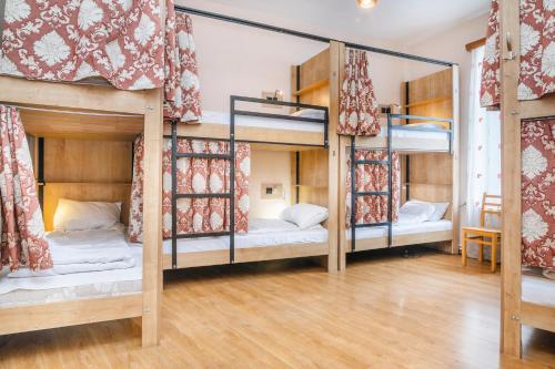 a room with three bunk beds in it at Pushkin 10 Hostel in Tbilisi City
