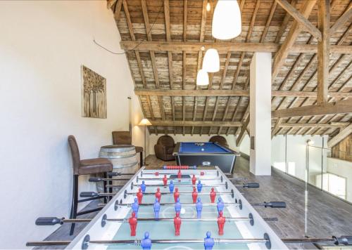 a ping pong table in the middle of a room at La Grange de Victor in Léglise