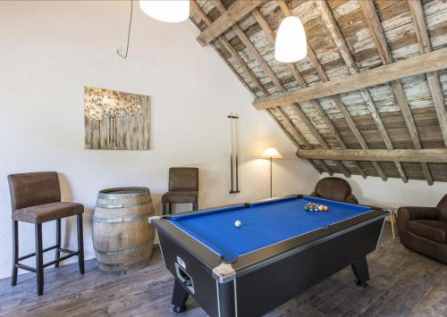 a room with a pool table and a barrel at La Grange de Victor in Léglise
