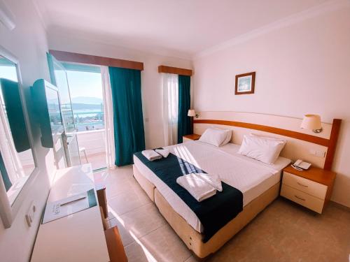 a bedroom with a bed and a large window at Afytos Bodrum in Mugla
