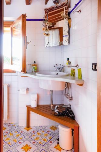a bathroom with a sink and a tile floor at Rosso Del Chianti in Panzano