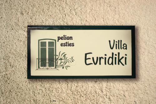 a sign on the wall of a building at Villa Evridiki by Pelion Esties in Agios Georgios Nilias