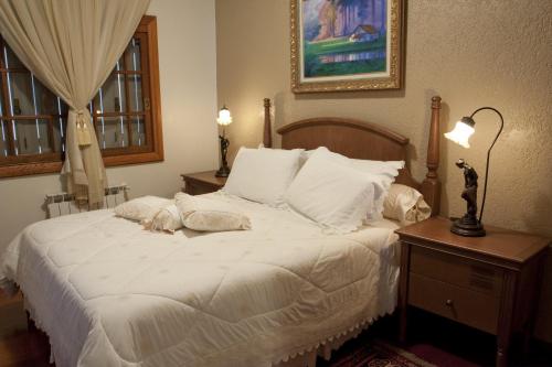 Hotel Pousada Florençaにあるベッド